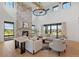 Open living room with high ceilings, stone fireplace, hardwood floors, and large windows at 2442 Fox View Trl, Franktown, CO 80116