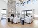 Bright living room featuring a stone fireplace and comfy seating at 2442 Fox View Trl, Franktown, CO 80116