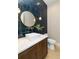 Stylish powder room with a navy tile feature wall at 2442 Fox View Trl, Franktown, CO 80116