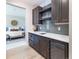 Wet bar with microwave, beverage fridge, and gray tile backsplash at 2442 Fox View Trl, Franktown, CO 80116