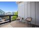 Cozy balcony with two chairs, a table, and a view of the surrounding neighborhood at 10165 E 59Th Ave, Denver, CO 80238