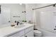 Well-lit bathroom with a tub and shower combination, white vanity, and modern fixtures at 10165 E 59Th Ave, Denver, CO 80238