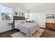 Comfortable bedroom featuring a bed, two windows for natural light, and neutral décor at 10165 E 59Th Ave, Denver, CO 80238