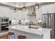 Bright kitchen with stainless steel appliances, quartz countertops, and a center island with seating at 10165 E 59Th Ave, Denver, CO 80238