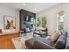 Cozy living room featuring a fireplace, modern decor, and a comfortable sectional sofa at 10165 E 59Th Ave, Denver, CO 80238