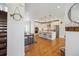 Spacious open concept showing the entry way, kitchen, dining area and wooden staircase at 10165 E 59Th Ave, Denver, CO 80238
