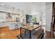 Open living space with a kitchen, dining table, and living room with hardwood floors and recessed lighting at 10165 E 59Th Ave, Denver, CO 80238