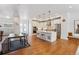 Open-concept living space with hardwood floors, a modern kitchen, and a dining area at 10165 E 59Th Ave, Denver, CO 80238