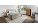 Serene main bedroom featuring a comfortable bed, dresser, and windows for natural light at 10165 E 59Th Ave, Denver, CO 80238