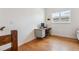 Cozy office space with hardwood floors, a light blue desk, and a window for natural light at 10165 E 59Th Ave, Denver, CO 80238