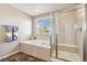Bright bathroom featuring separate shower and soaking tub at 42311 Forest Oaks Dr, Elizabeth, CO 80107