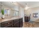 Well-lit bathroom featuring double sinks, spacious mirror, and modern fixtures at 42311 Forest Oaks Dr, Elizabeth, CO 80107