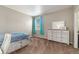 Bright bedroom featuring a window with turquoise curtains and a dresser, creating a tranquil personal space at 42311 Forest Oaks Dr, Elizabeth, CO 80107