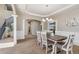 Elegant dining room with a tray ceiling, stylish chandelier, and wainscoting, perfect for Gathering gatherings at 42311 Forest Oaks Dr, Elizabeth, CO 80107