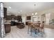 Well-appointed kitchen with an island, granite counters, dark cabinets, and a dining area, ideal for gatherings at 42311 Forest Oaks Dr, Elizabeth, CO 80107