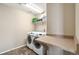 Convenient laundry room equipped with modern washer, dryer and folding table at 42311 Forest Oaks Dr, Elizabeth, CO 80107
