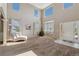 Bright living room with soaring ceilings, large windows, and a cozy chaise lounge for ultimate relaxation at 42311 Forest Oaks Dr, Elizabeth, CO 80107
