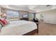 Bright main bedroom with two large windows and an en-suite bathroom at 42311 Forest Oaks Dr, Elizabeth, CO 80107