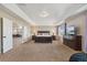 Spacious main bedroom with tray ceiling, flatscreen TV, and adjoining office at 42311 Forest Oaks Dr, Elizabeth, CO 80107
