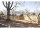 Large backyard with a wooden fence and mature tree at 7883 S Windermere Cir, Littleton, CO 80120