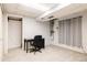 Basement room with carpet, desk, and sliding barn door at 7883 S Windermere Cir, Littleton, CO 80120
