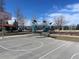 Community basketball court near modern playground under a bright blue sky offering outdoor activities and recreational space at 7883 S Windermere Cir, Littleton, CO 80120