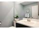 Bathroom features a vanity with sink, toilet, and decorative accents at 7883 S Windermere Cir, Littleton, CO 80120