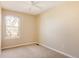 Bedroom features a window, ceiling fan, and carpet at 7883 S Windermere Cir, Littleton, CO 80120