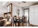 Dining room with fireplace, seating, and wood floors at 7883 S Windermere Cir, Littleton, CO 80120