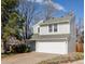 Two-story home featuring a well-maintained lawn, mature trees and a two car garage at 7883 S Windermere Cir, Littleton, CO 80120