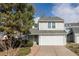 Charming two-story home featuring a well-maintained lawn, mature trees and a two car garage at 7883 S Windermere Cir, Littleton, CO 80120