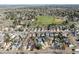A wide aerial shot showing the property nestled within a residential neighborhood near a large park and community green space at 7883 S Windermere Cir, Littleton, CO 80120
