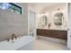 Spa-like bathroom with a modern soaking tub, double vanity, and sleek fixtures at 3649 W 21St Ave, Denver, CO 80211