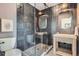 Modern bathroom with glass-enclosed shower, stylish fixtures, and sleek gray tiling at 3649 W 21St Ave, Denver, CO 80211