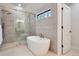 Modern bathroom featuring a stylish walk-in shower and a soaking tub at 3649 W 21St Ave, Denver, CO 80211
