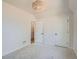 This empty bedroom features a modern chandelier, neutral walls and carpet, and two doors at 3649 W 21St Ave, Denver, CO 80211