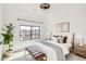 Bright bedroom features neutral decor, stylish furnishings, and a large window for ample natural light at 3649 W 21St Ave, Denver, CO 80211