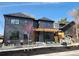 Modern home with dark gray siding, a pergola over the front entrance, and manicured landscaping at 3649 W 21St Ave, Denver, CO 80211