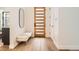 Welcoming foyer with a modern wood door, minimalist bench, and bright, open space at 3649 W 21St Ave, Denver, CO 80211