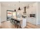 Bright kitchen features a waterfall island, stainless appliances, and easy access to the outdoor patio at 3649 W 21St Ave, Denver, CO 80211