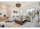 Inviting living room with large windows, comfortable seating, stylish decor, and an elegant chandelier at 3649 W 21St Ave, Denver, CO 80211