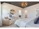 Elegant main bedroom featuring a modern chandelier, a seating area, and a view into the en-suite bathroom at 3649 W 21St Ave, Denver, CO 80211