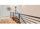 Modern staircase with sleek railing and light hardwood flooring at 3649 W 21St Ave, Denver, CO 80211