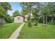 A sprawling backyard with a walkway leading to a shaded patio area at 422 Atwood St, Longmont, CO 80501