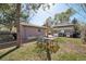 A spacious backyard with a patio, grill, and mature trees provides ample space for outdoor gatherings at 422 Atwood St, Longmont, CO 80501