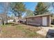 A spacious backyard with a small outbuilding, patio, and mature trees provides ample outdoor space at 422 Atwood St, Longmont, CO 80501
