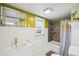 Bright bathroom with modern vanity, decorative mirror, and shower with stylish curtain and wood-look tile surround at 422 Atwood St, Longmont, CO 80501