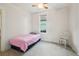 A cozy bedroom with a twin bed features natural light and neutral walls at 422 Atwood St, Longmont, CO 80501
