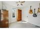 Cozy bedroom with a built-in bookcase and guitars, offering ample natural light from a window at 422 Atwood St, Longmont, CO 80501