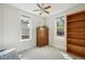 Inviting bedroom with two windows, a ceiling fan, a dresser, and built-in shelving for ample storage at 422 Atwood St, Longmont, CO 80501